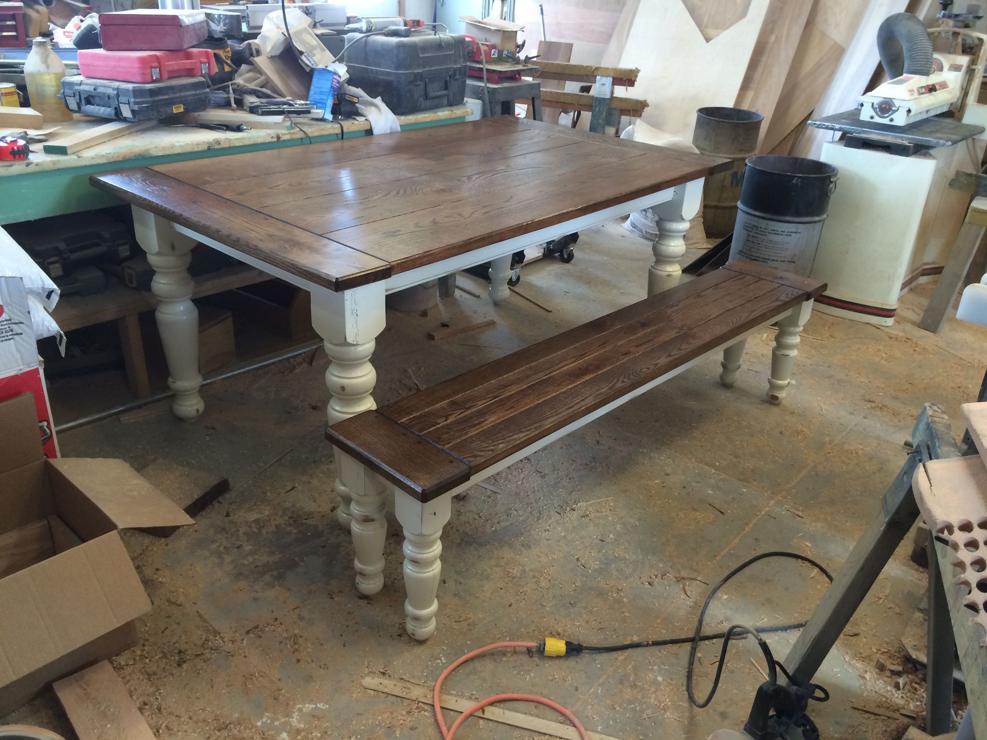 A wooden table with a bench underneath it