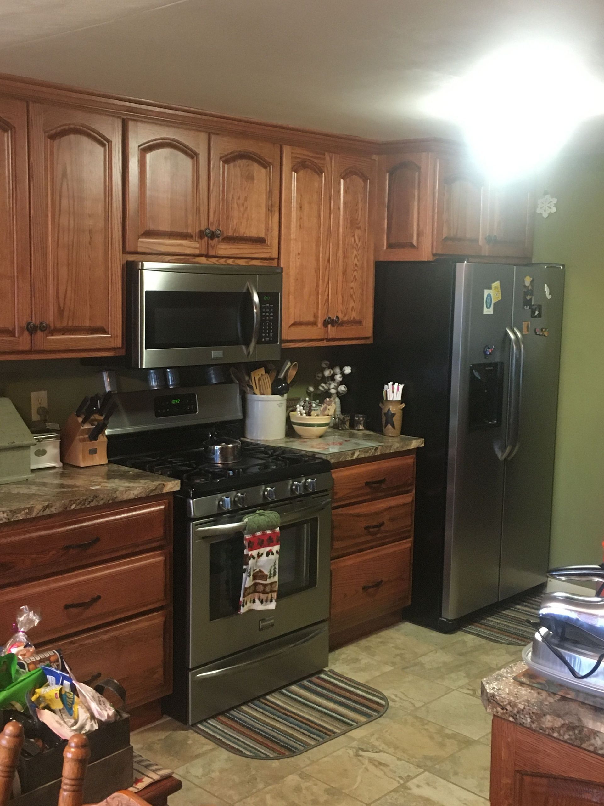 A kitchen with stainless steel appliances and wooden cabinets