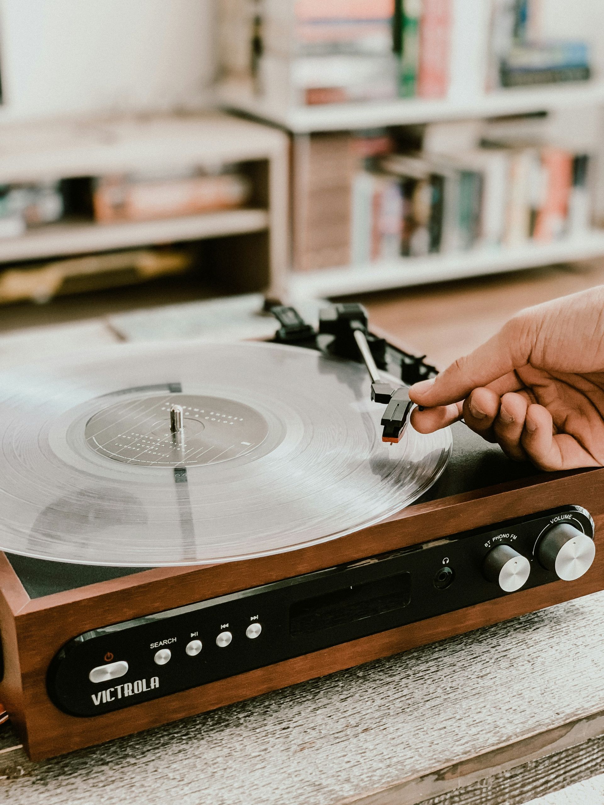 A person is playing a record on a record player.