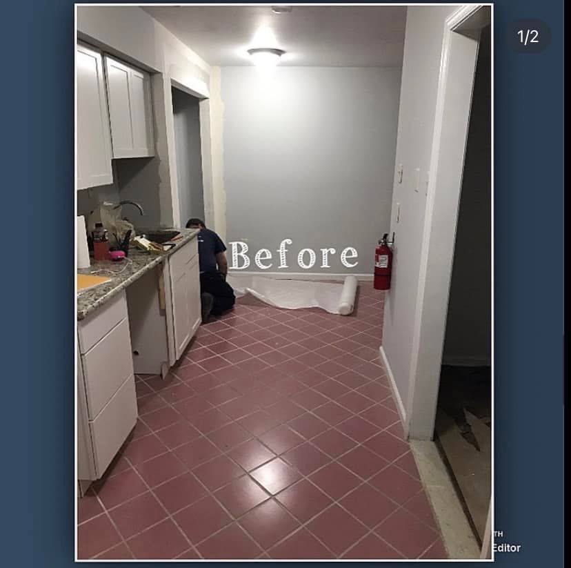 Narrow kitchen before remodel with pink tile floor, white cabinets, and a fire extinguisher on the right.