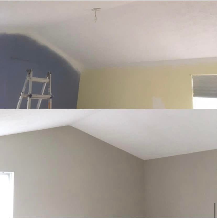 Interior room under renovation with a ladder, blue and beige painted walls, and a sloped ceiling.