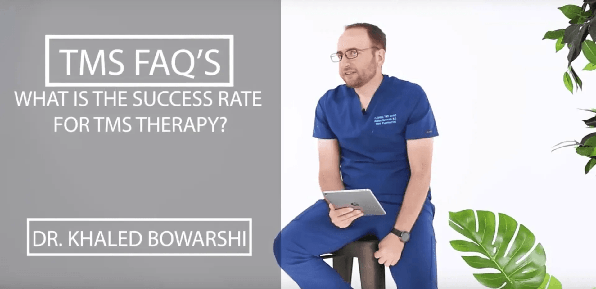 Man in blue scrubs holds tablet, answering questions about TMS therapy success rate.