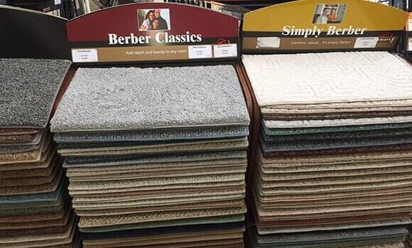 Two side-by-side retail displays of carpet samples labeled