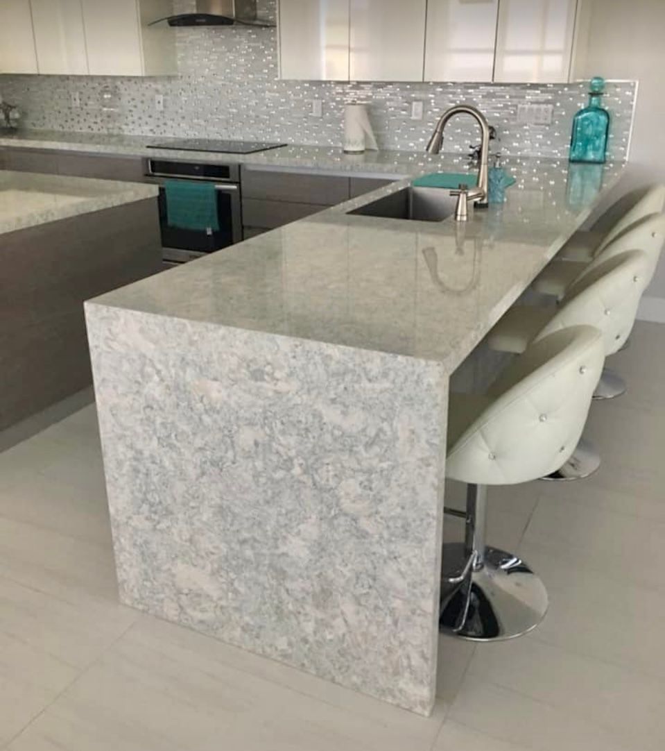 A kitchen with a large island and a sink