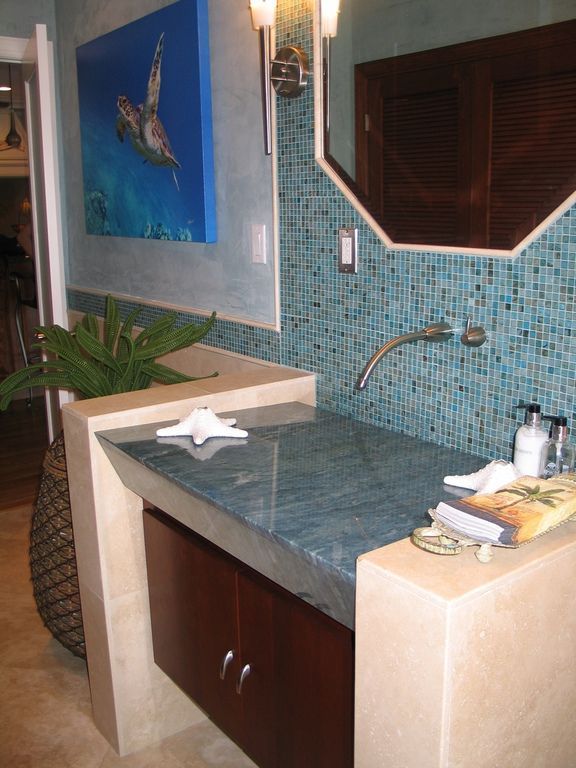 A bathroom with a painting of a turtle on the wall