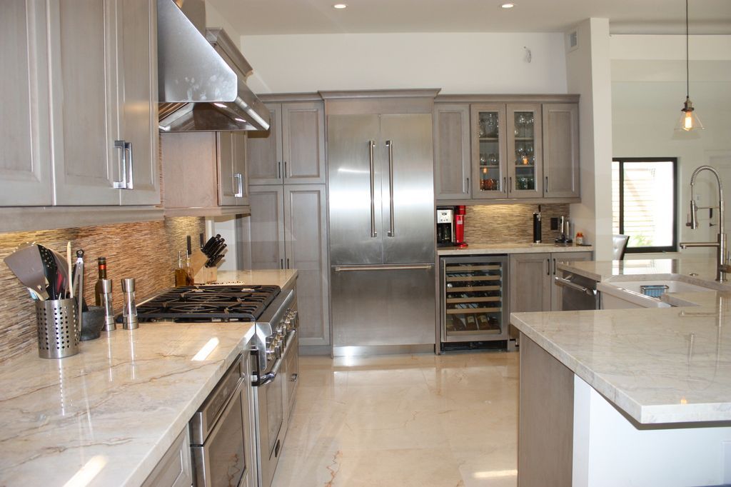 A kitchen with stainless steel appliances and granite counter tops