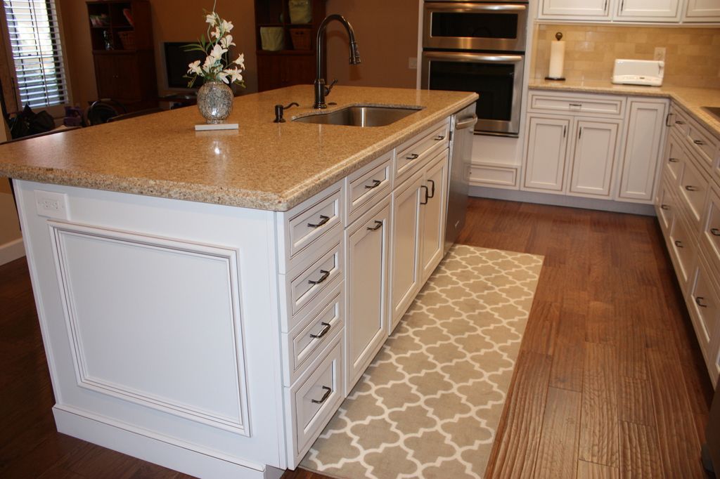 A kitchen with a large island and a sink