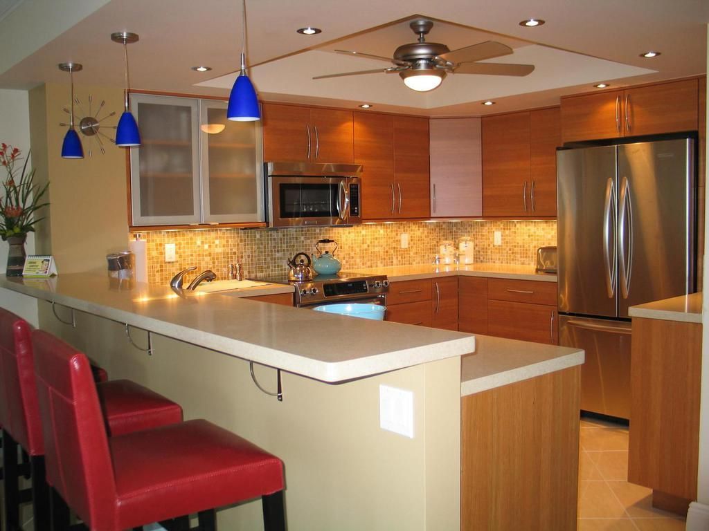 A kitchen with stainless steel appliances and wooden cabinets
