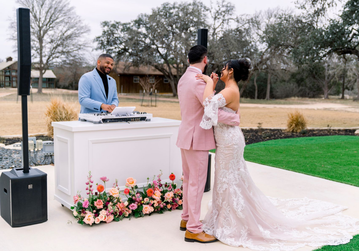 Wedding couple dancing in front of DJ booth