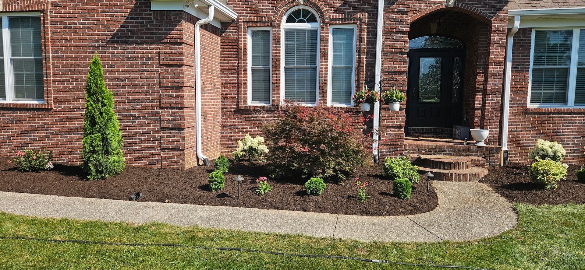 Exterior of a brick house with landscaping