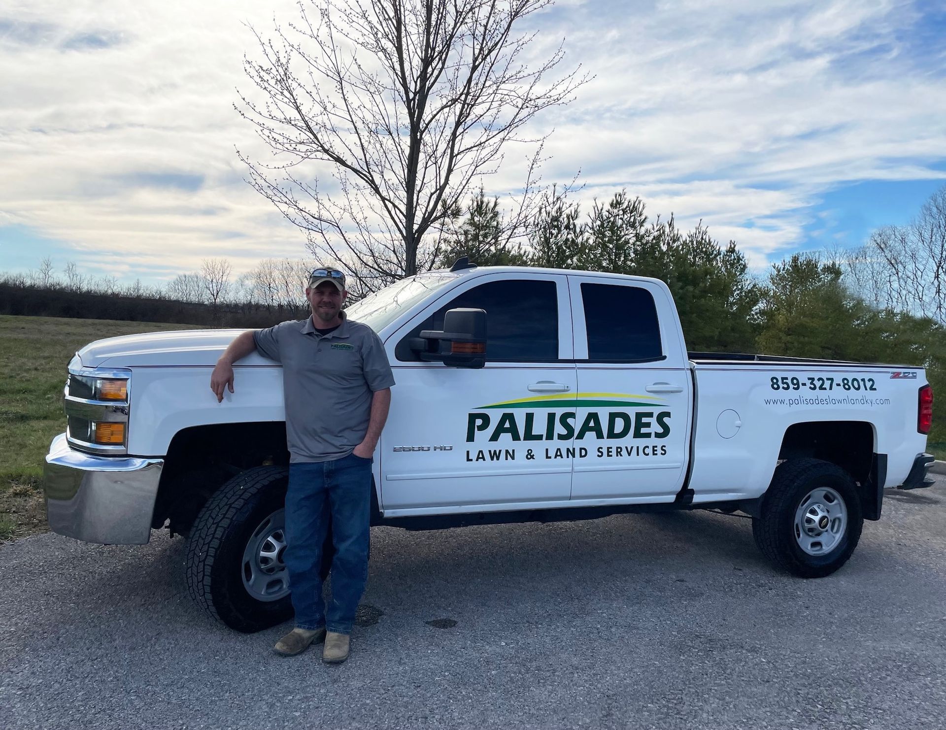 Man leans against white truck with 