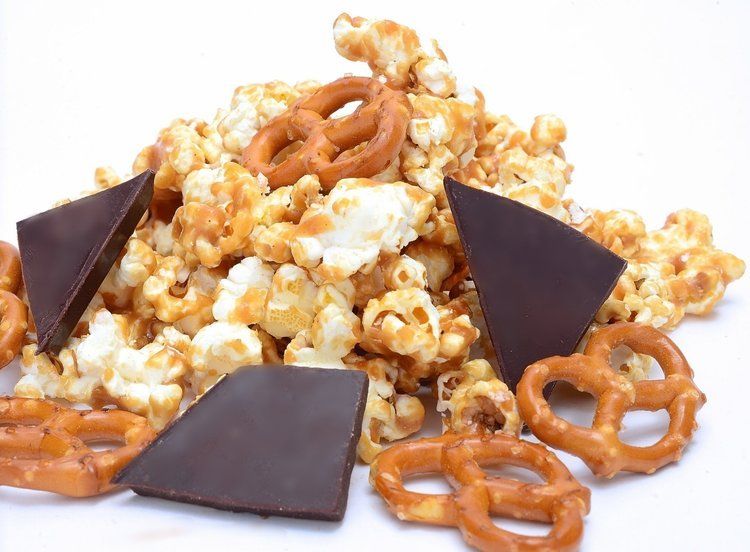 a pile of toffe popcorn pretzels and chocolate pieces