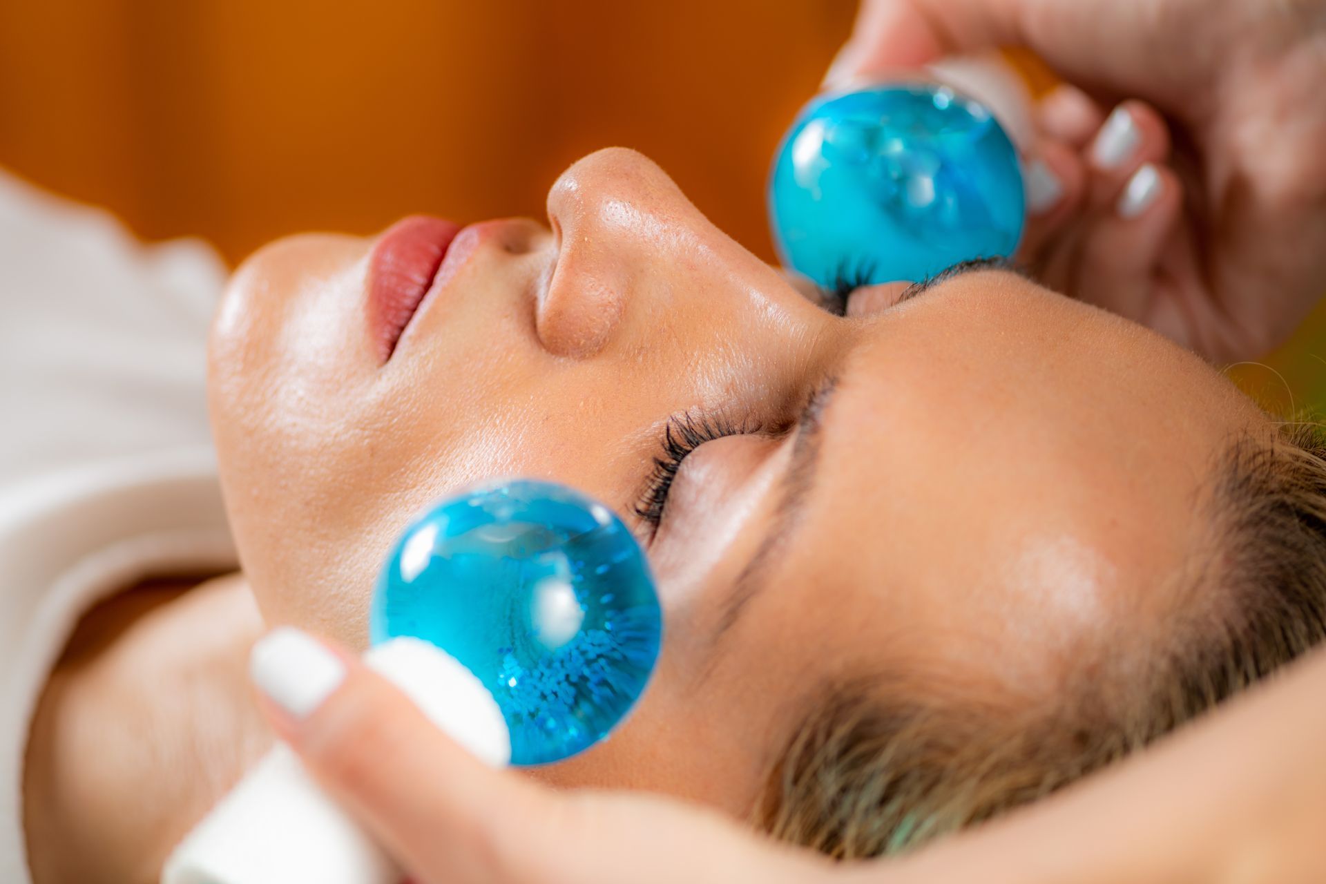 A woman is experiencing dermaplaning treatment. 