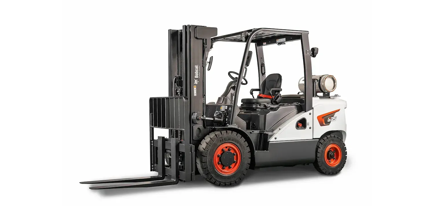 A forklift is sitting on a white surface.