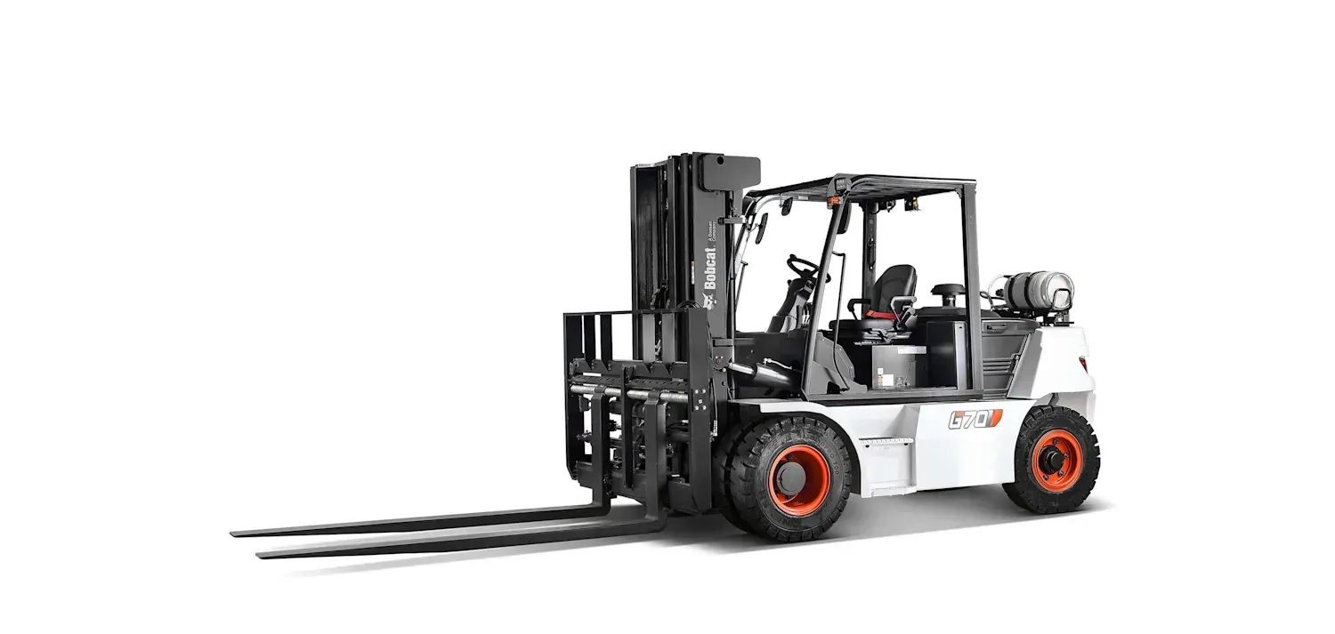 A forklift is sitting on a white surface.