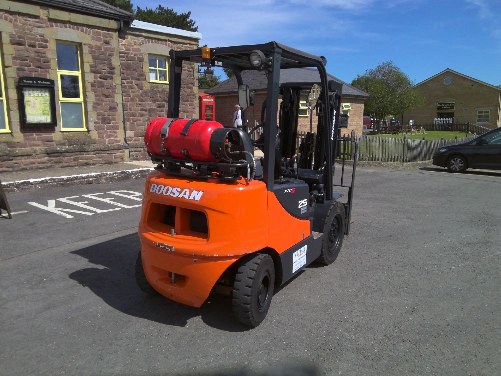A doosan forklift is parked in a parking lot
