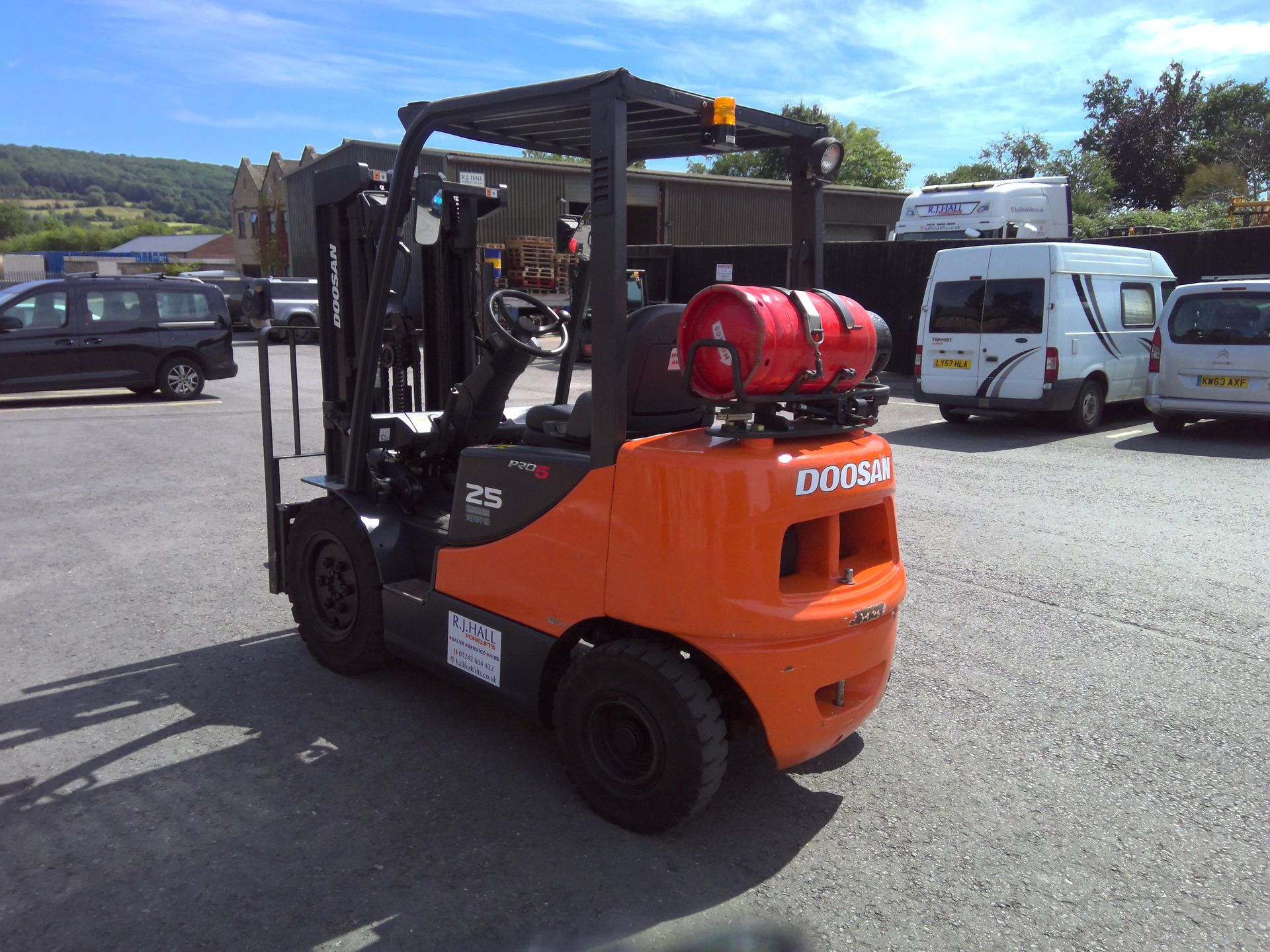 A doosan forklift is parked in a parking lot