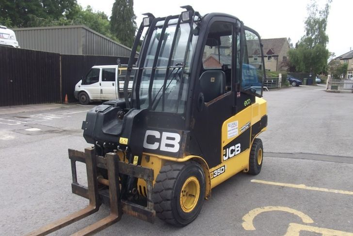 A yellow and black cb forklift is parked in a parking lot