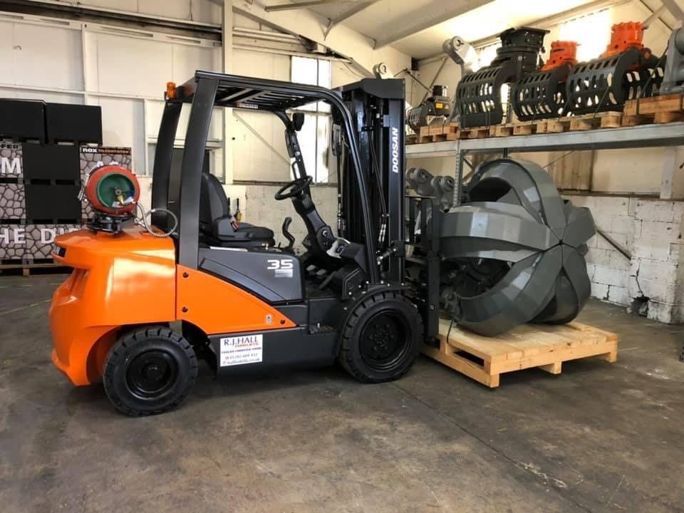 A forklift truck parked in a warehouse, ready for service by trained technicians to ensure reliable performance for time sensitive operations