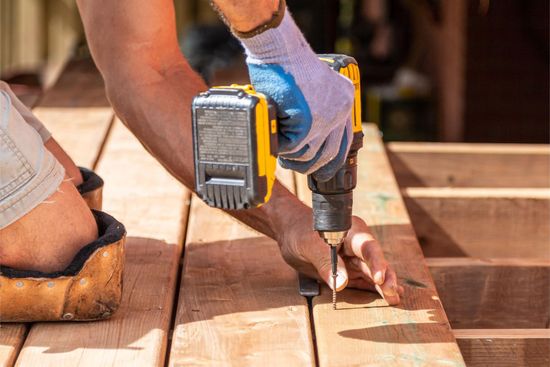 strong hands preparing wooden boards construction