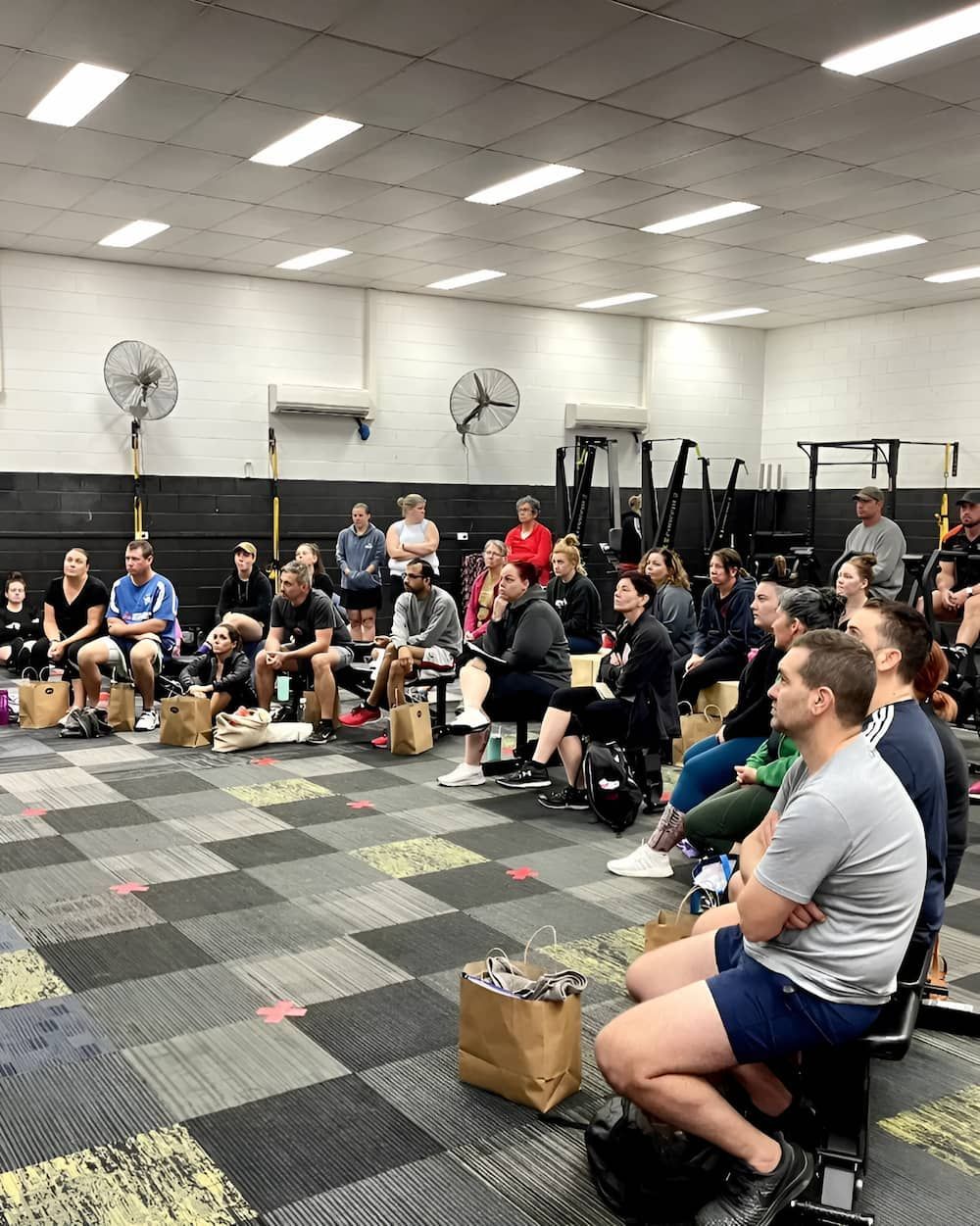 A Group Of People Are Sitting In A Gym Watching A Presentation — Ultimate Results Training in Aitkenvale, QLD