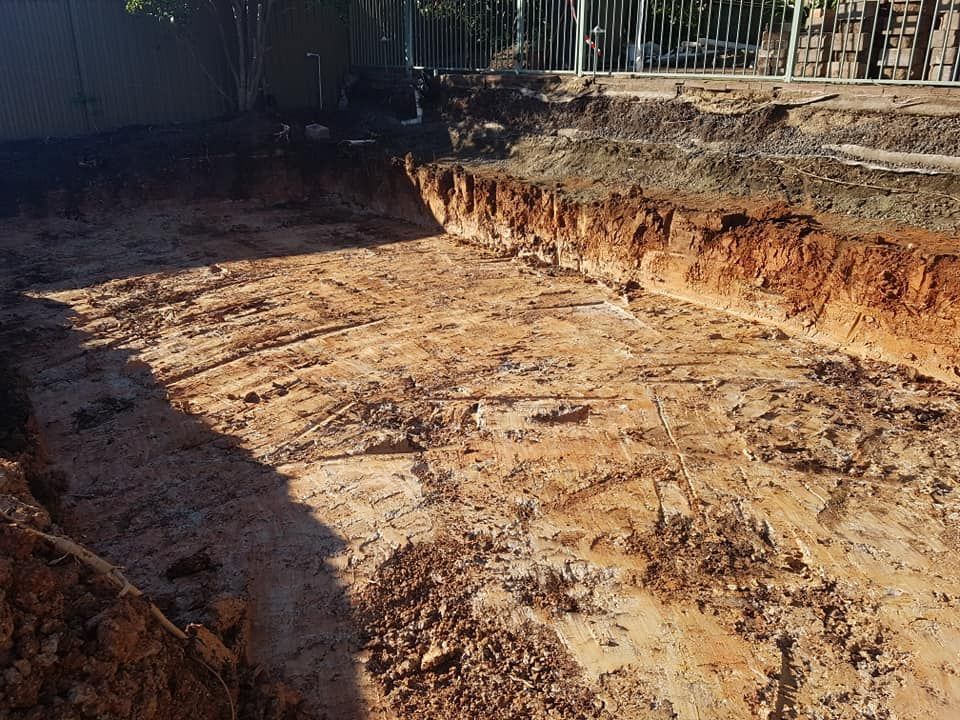 A large pile of dirt is sitting in the middle of a dirt field.