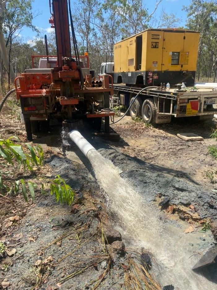 Water Gushing Out of a Gray Pipe Onto Reddish-brown Earth — FNQ Drilling in Bamboo, QLD