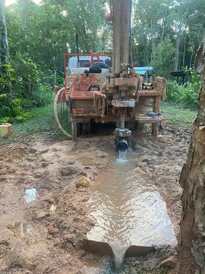 Two People in Blue Gloves Testing Water Samples Outdoors — FNQ Drilling in Georgetown, QLD
