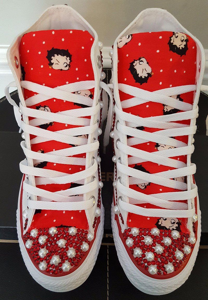 Red and white high-top sneakers with Betty Boop pattern, studded with pearls and rhinestones.