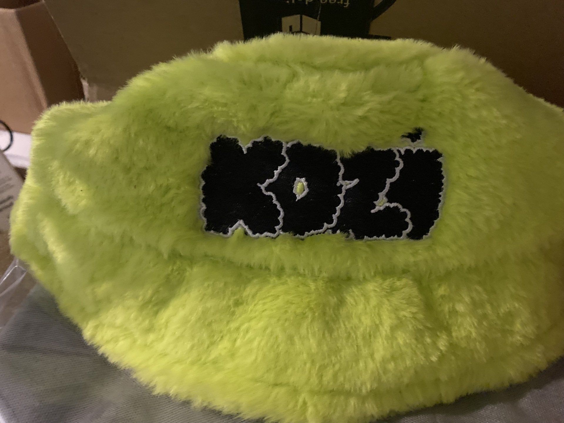A neon green hat with the word koz on it