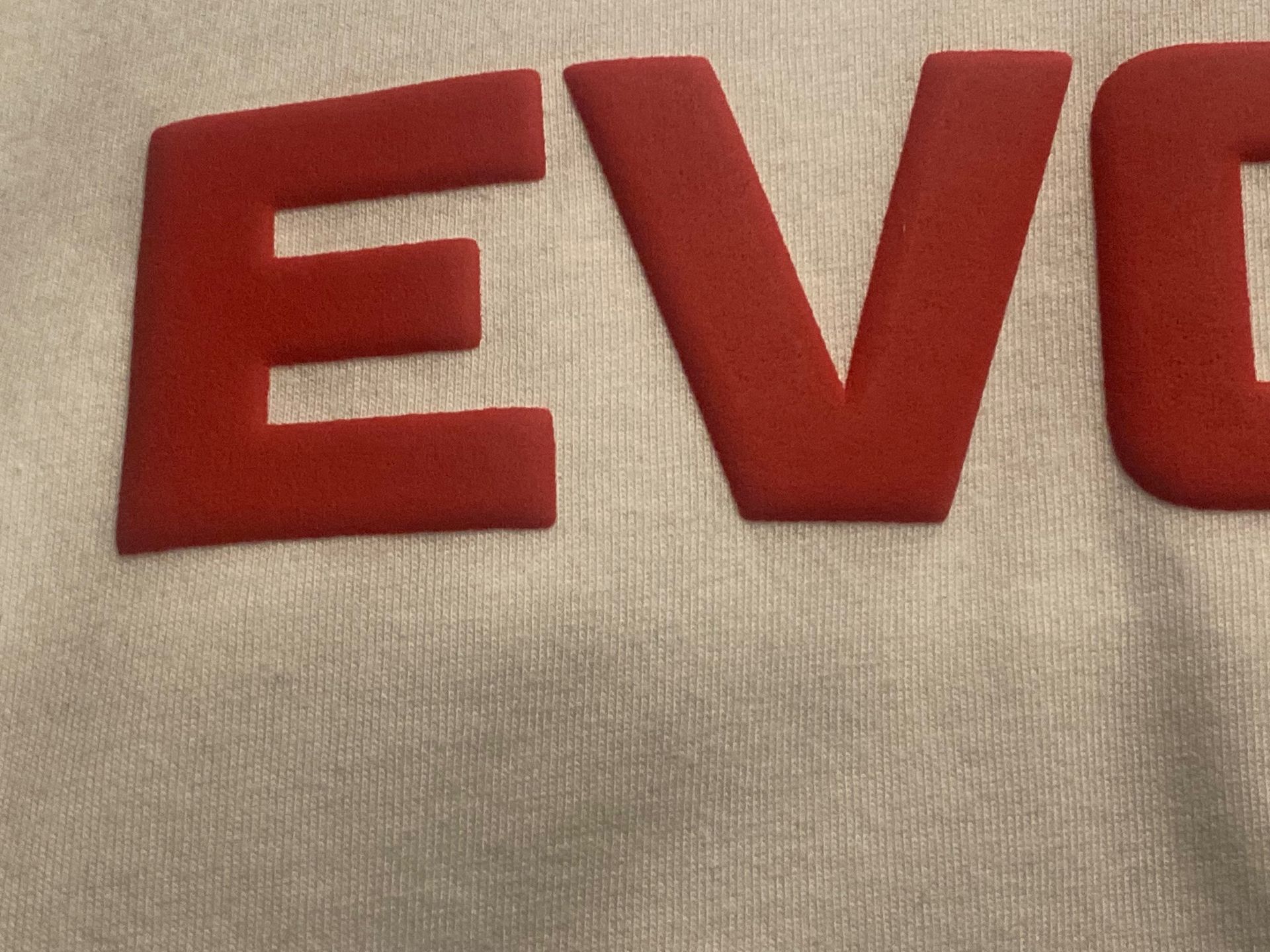 A white shirt with red letters that say evo