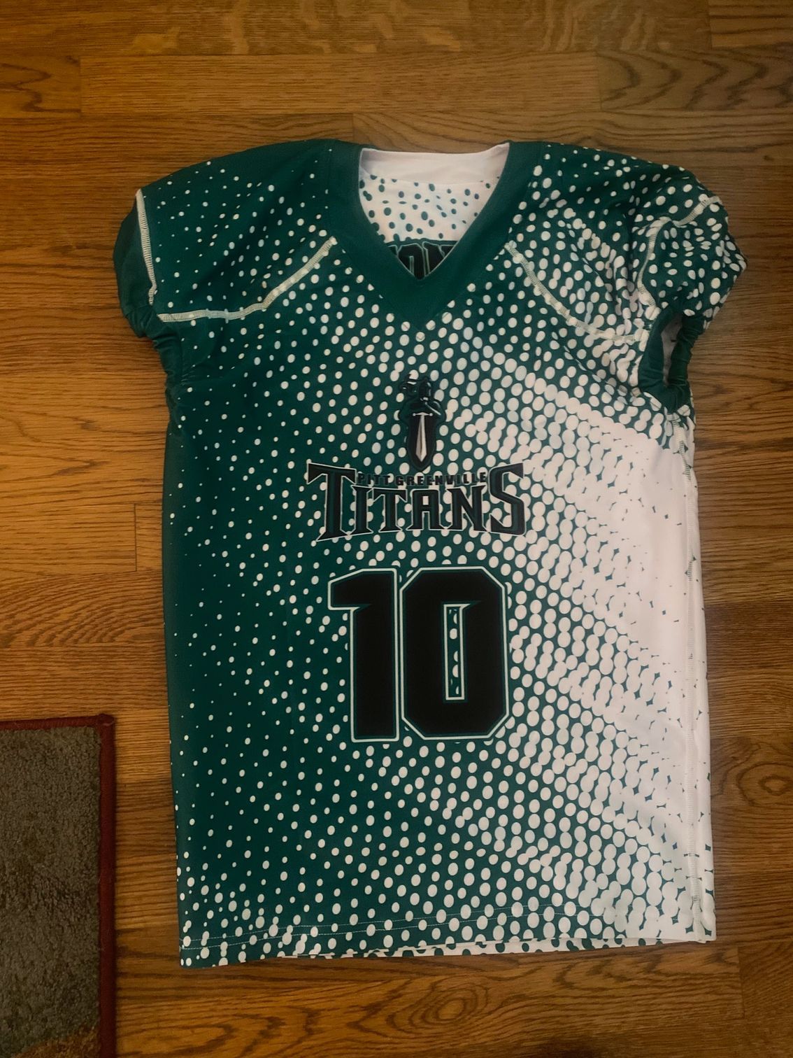 A green and white football jersey with the number 10 on it