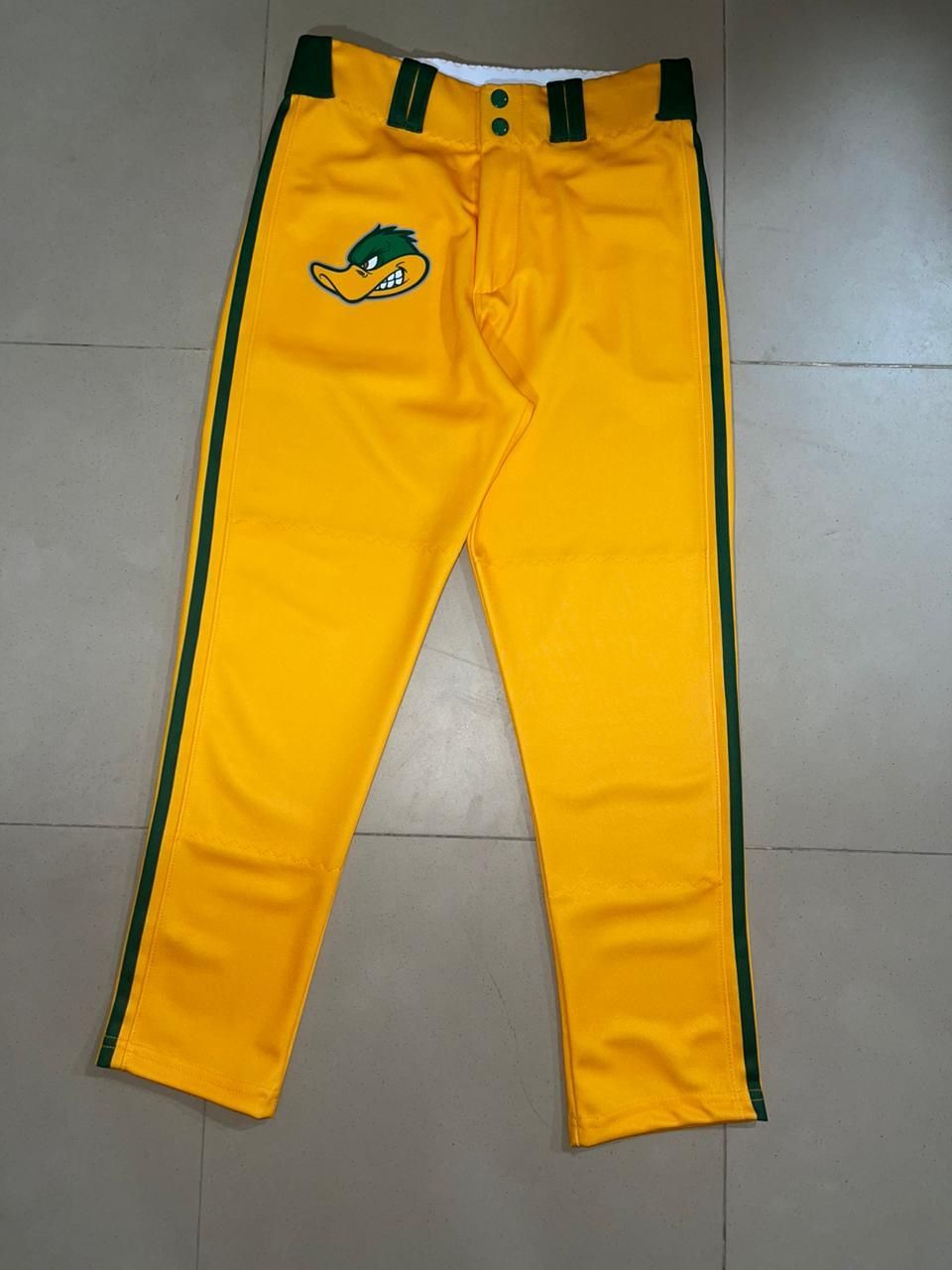A pair of yellow baseball pants with green stripes