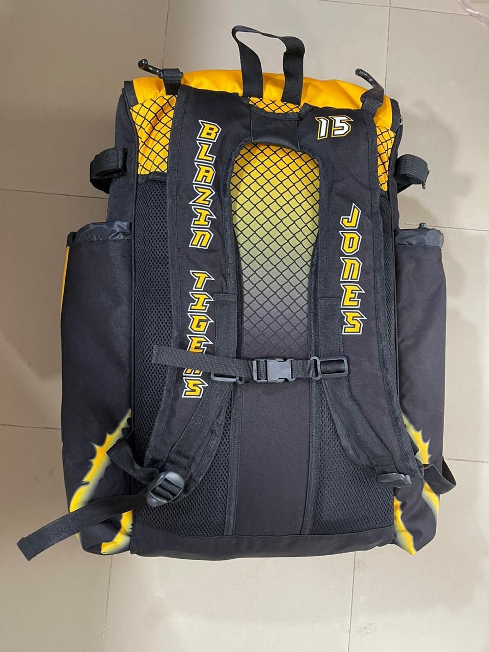 A black and yellow backpack with the number 15 on it