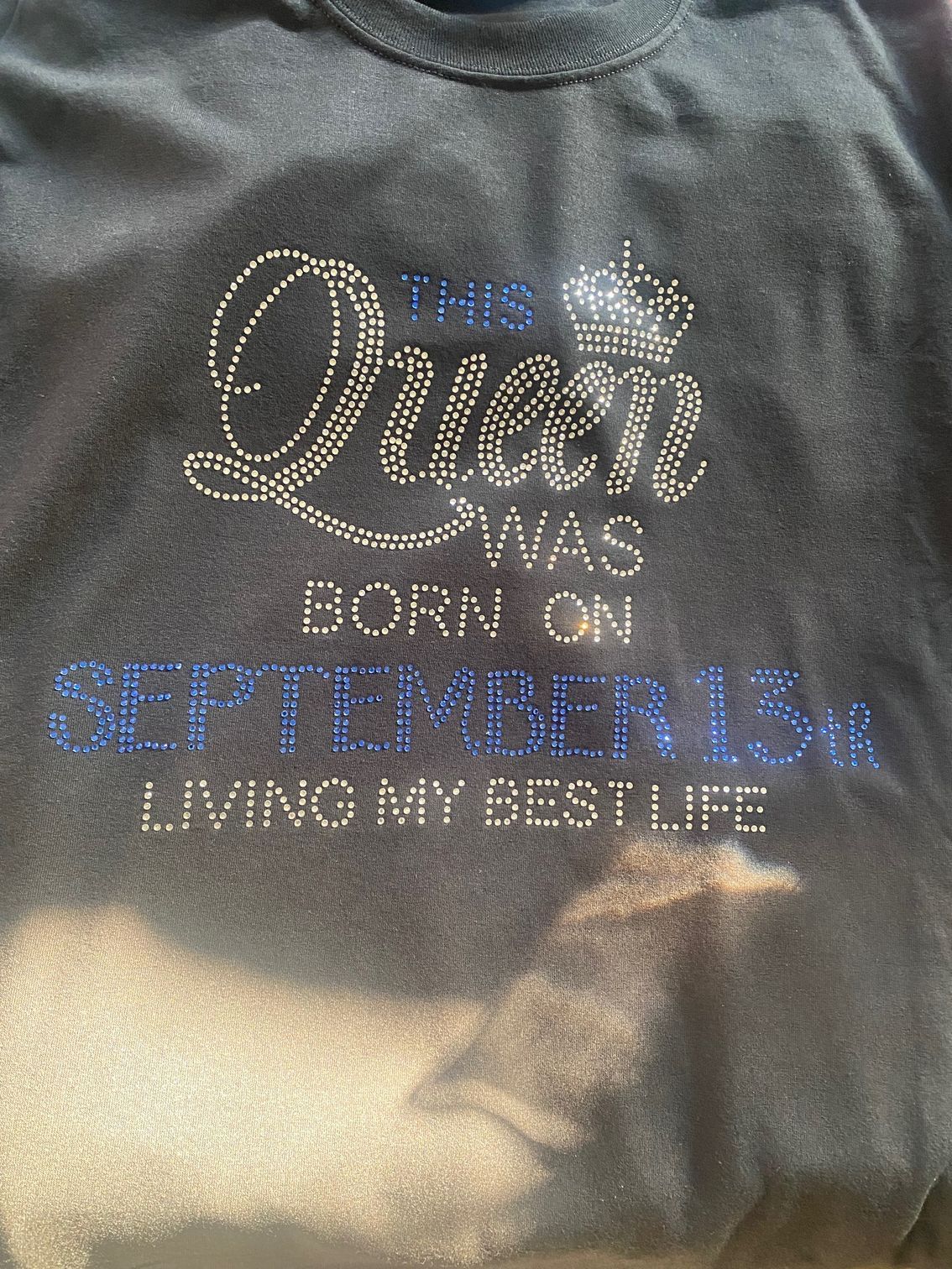 A black t-shirt with rhinestones on it that says `` queen was born on september 1st 2004 living my best life ''.
