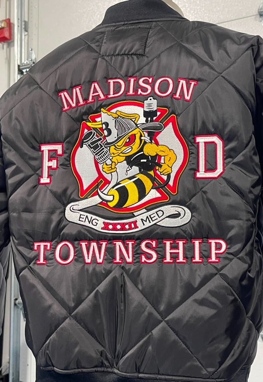 A black jacket with madison township embroidered on it