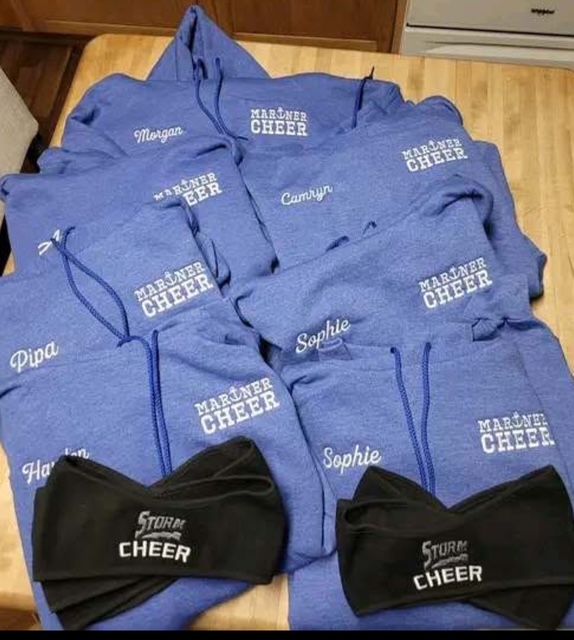 A bunch of sweatshirts that say marine cheer on them