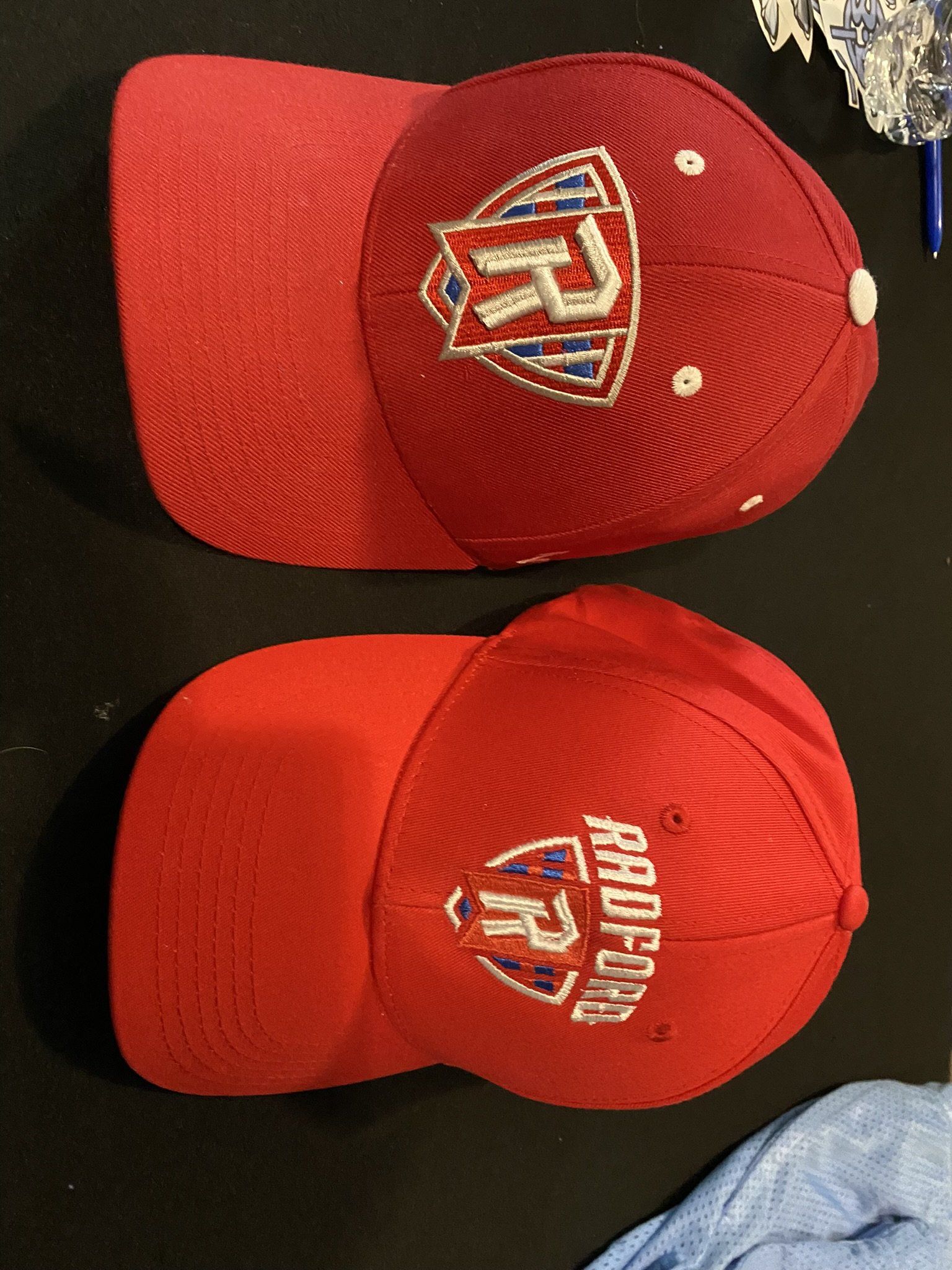 Two red hats one of which says pacific on it