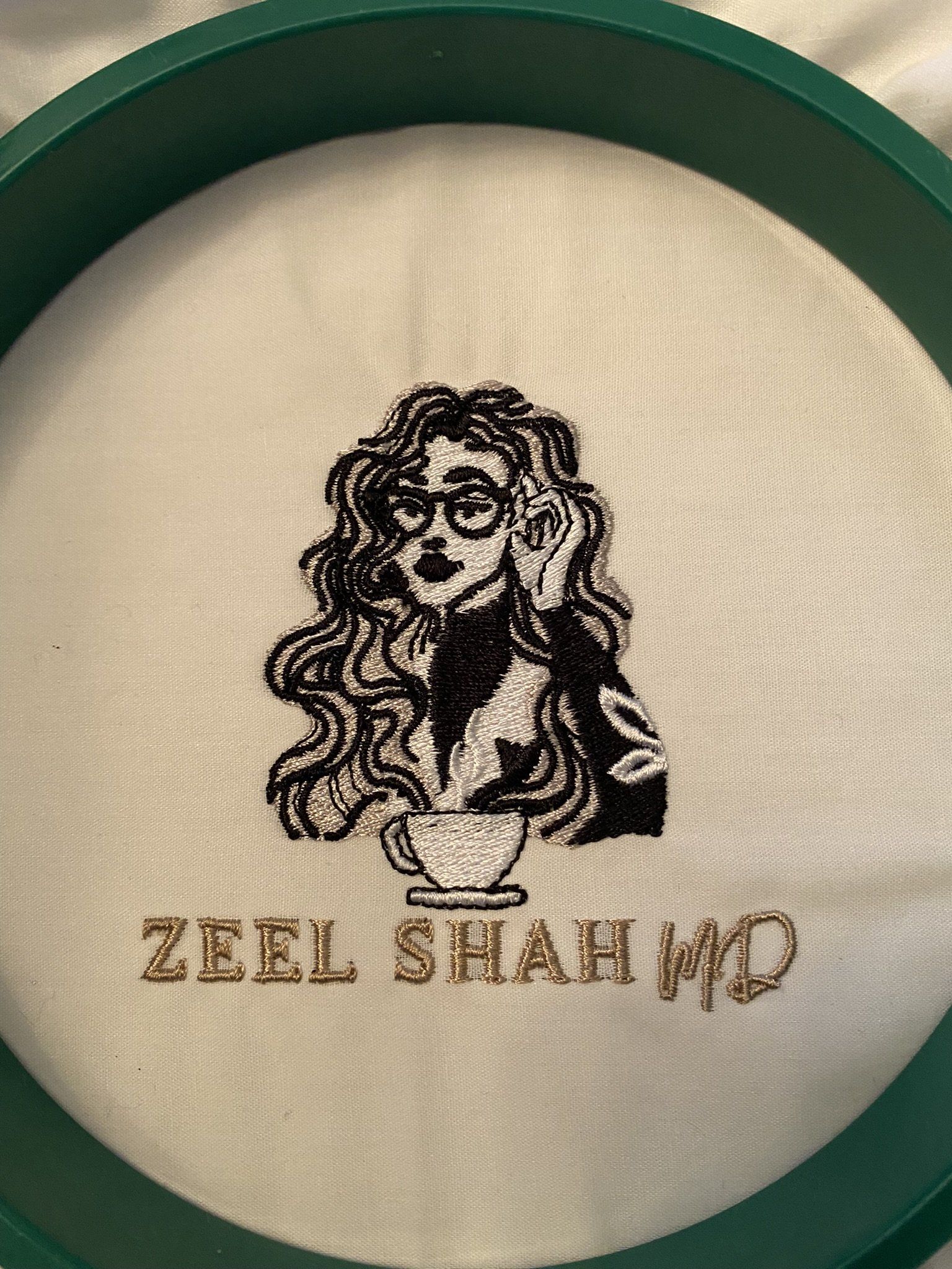 A close up of a embroidery hoop with a picture of a woman on it.