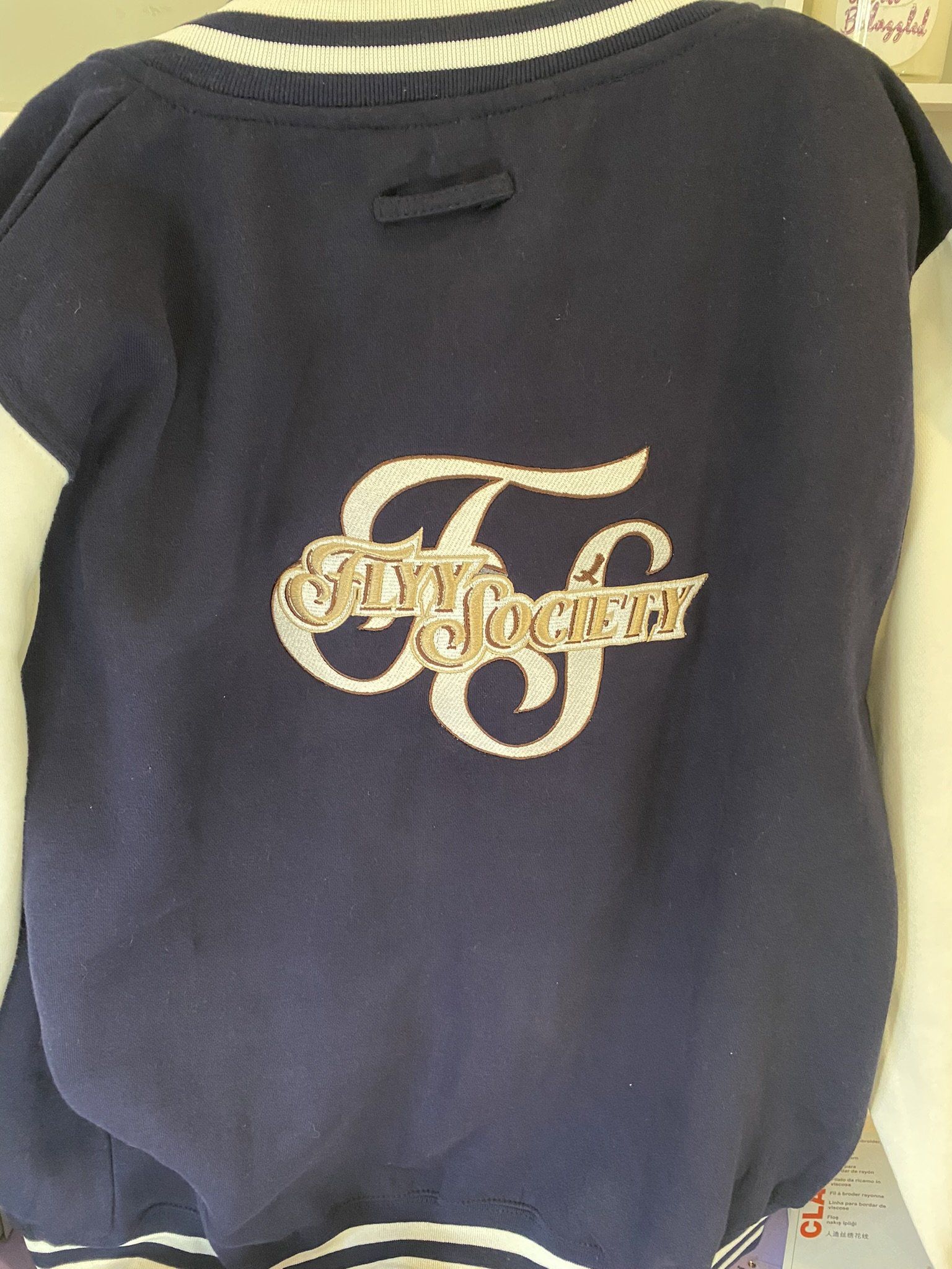A blue shirt with the letter f on it