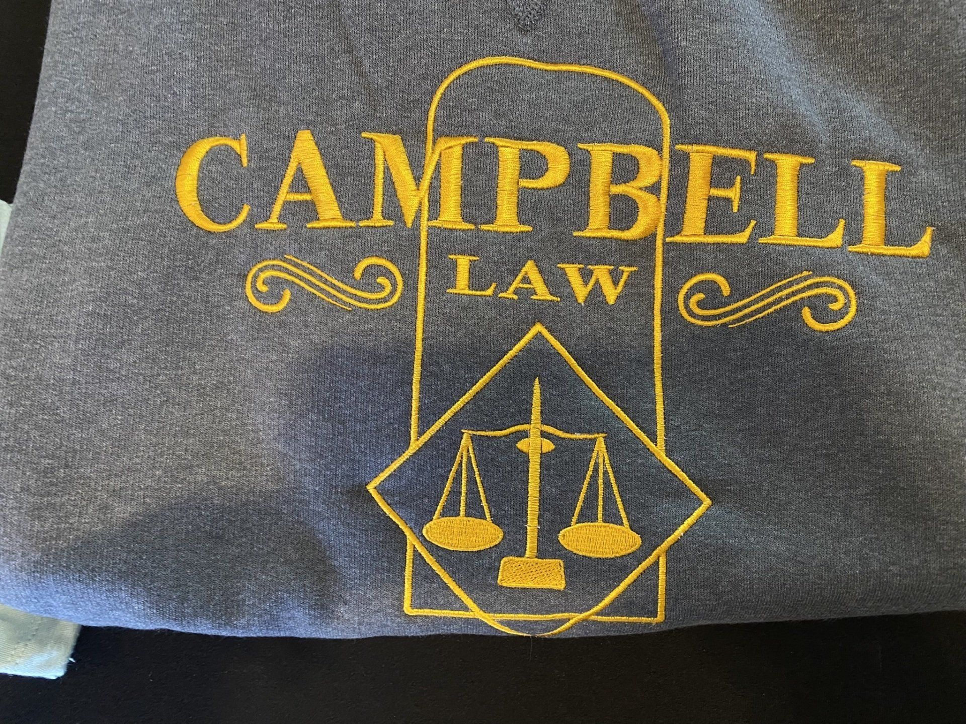 A grey shirt with campbell law written on it