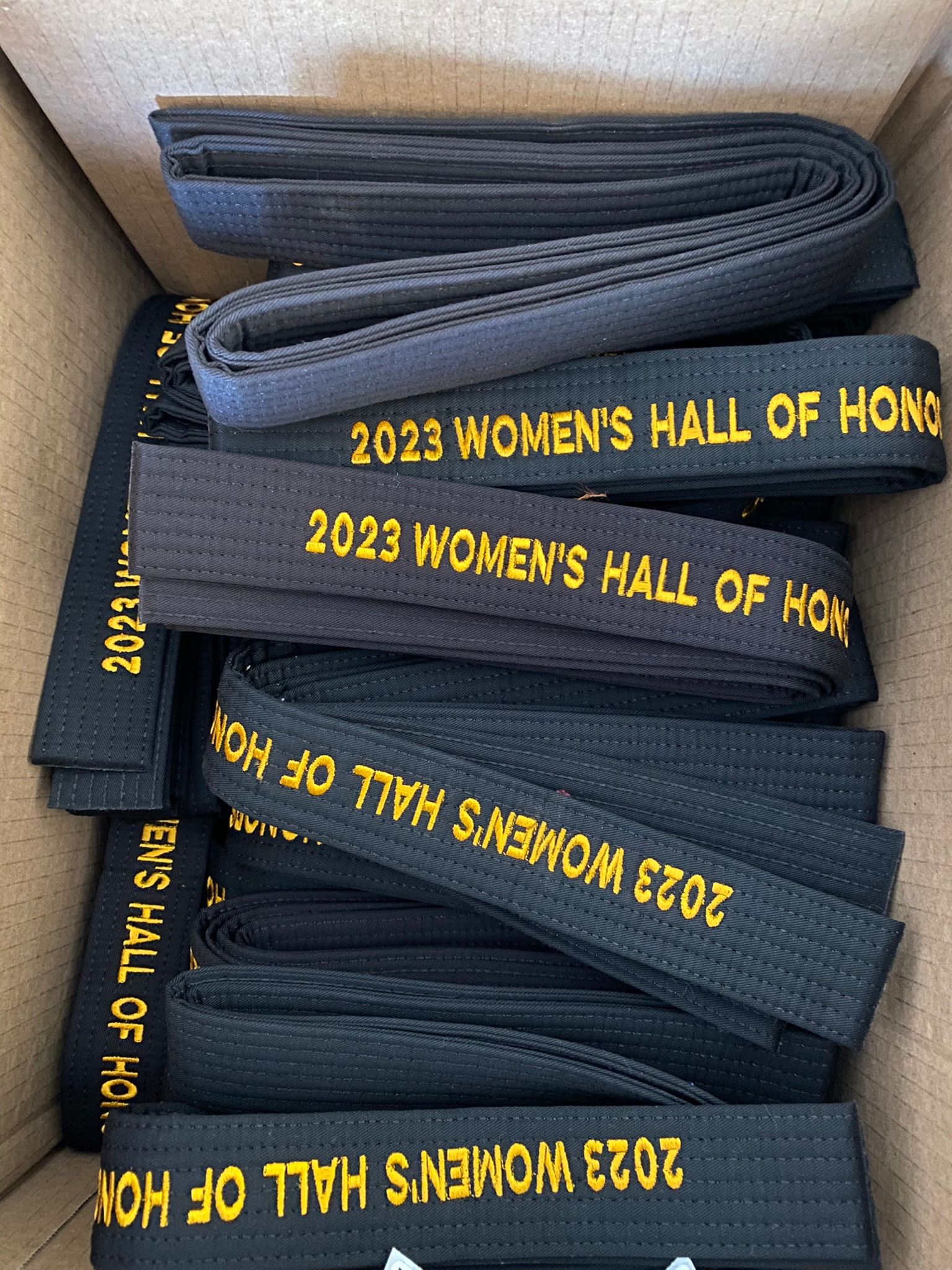 A box filled with black belts for the women 's hall of honor.