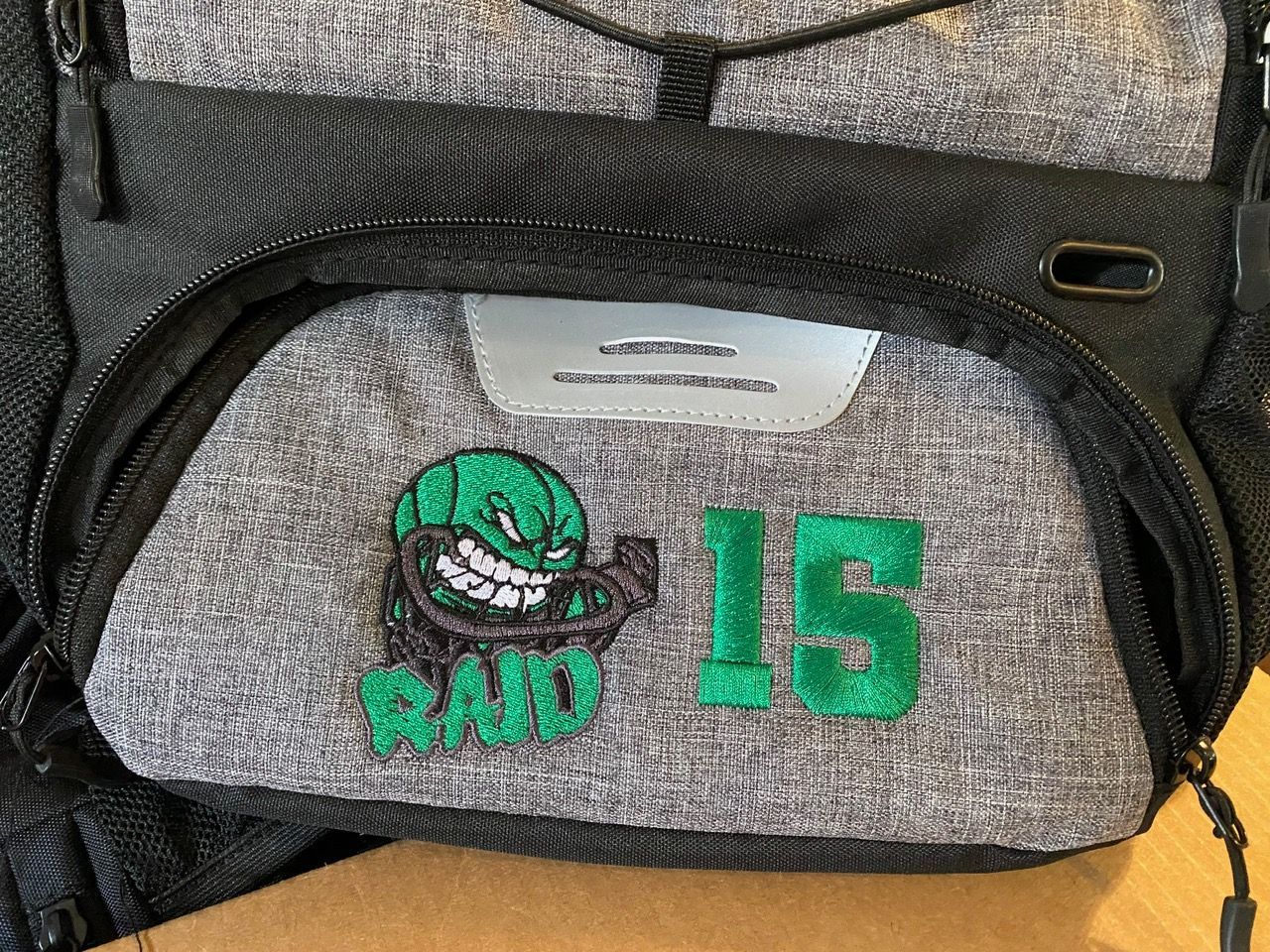 A backpack with the number 15 embroidered on it