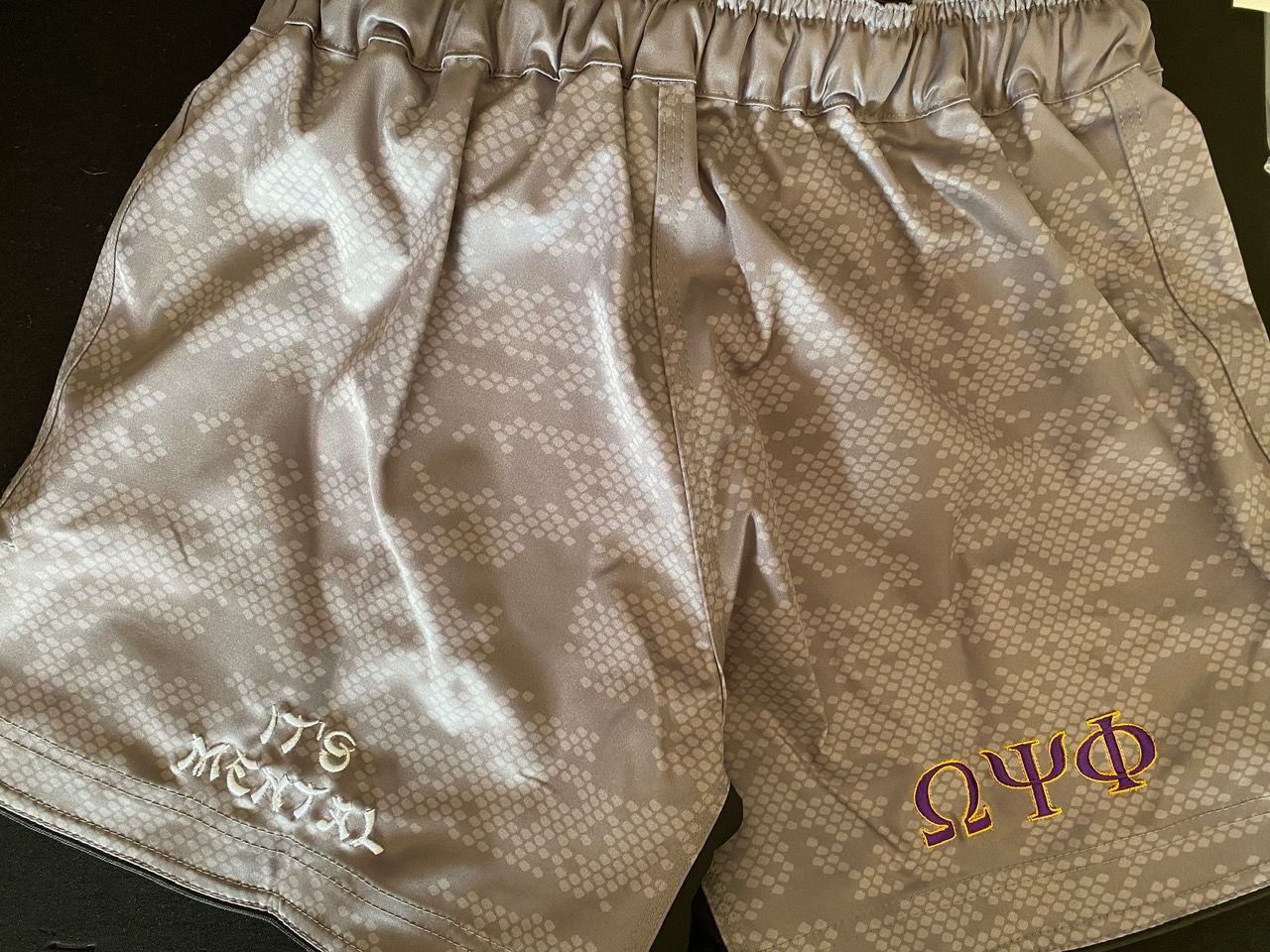 A pair of shorts with greek writing on them
