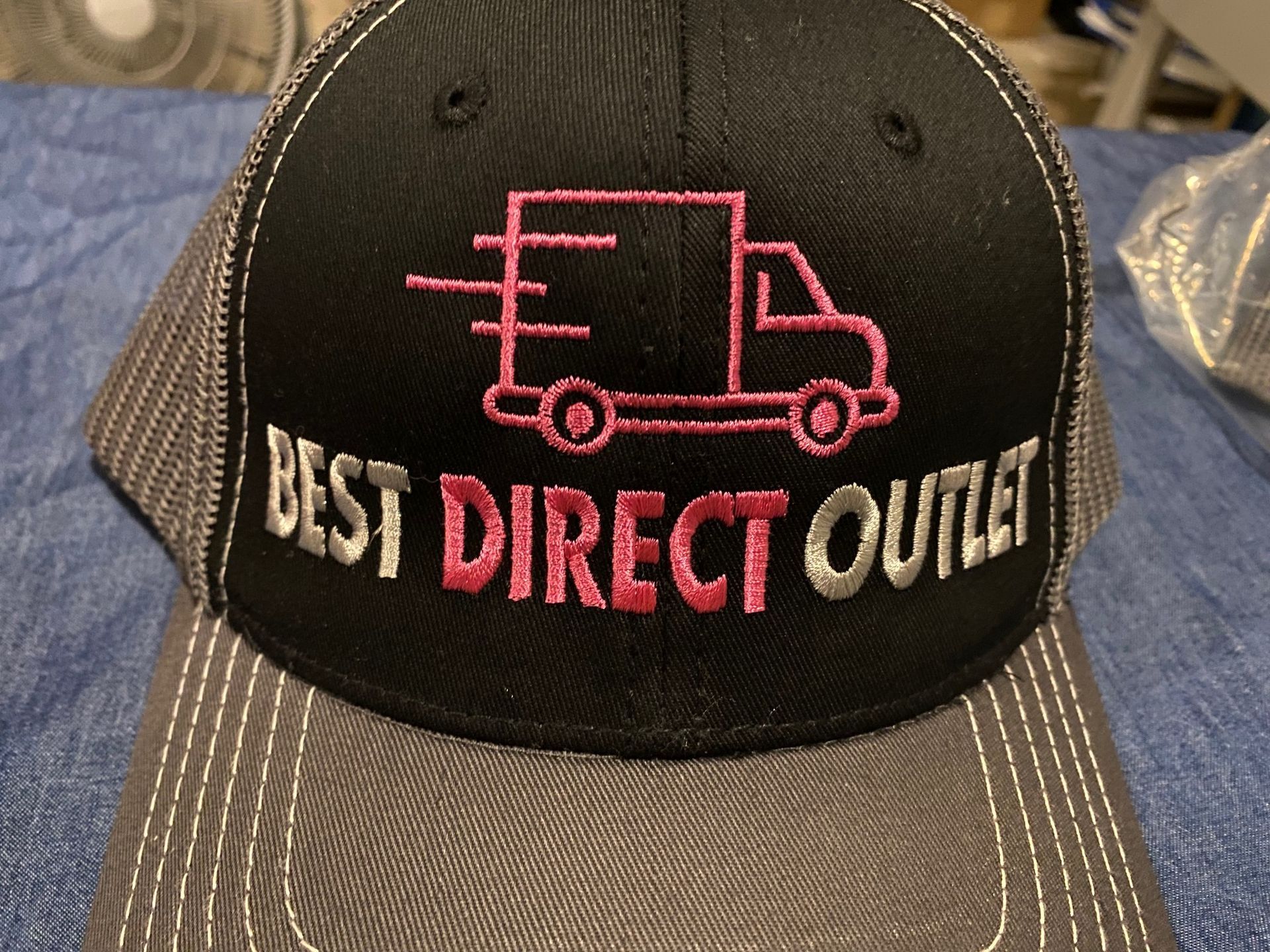 A hat that says best direct outlet on it