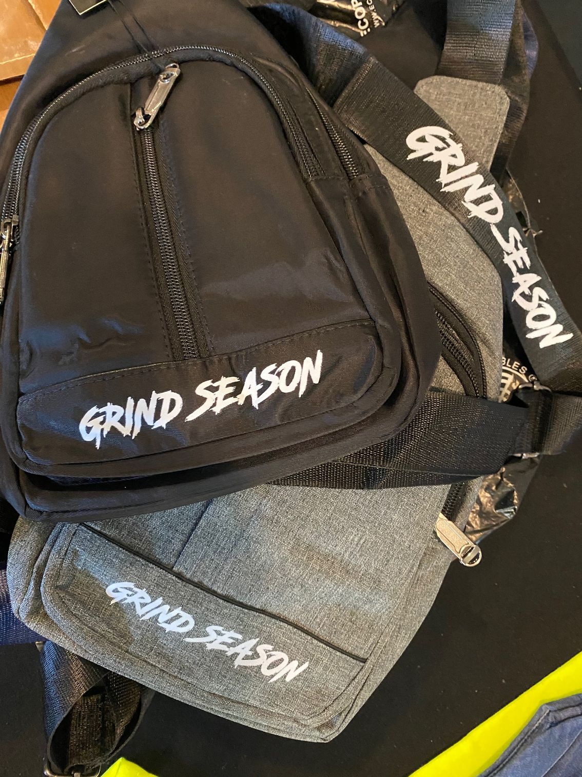 Three bags are stacked on top of each other on a table.