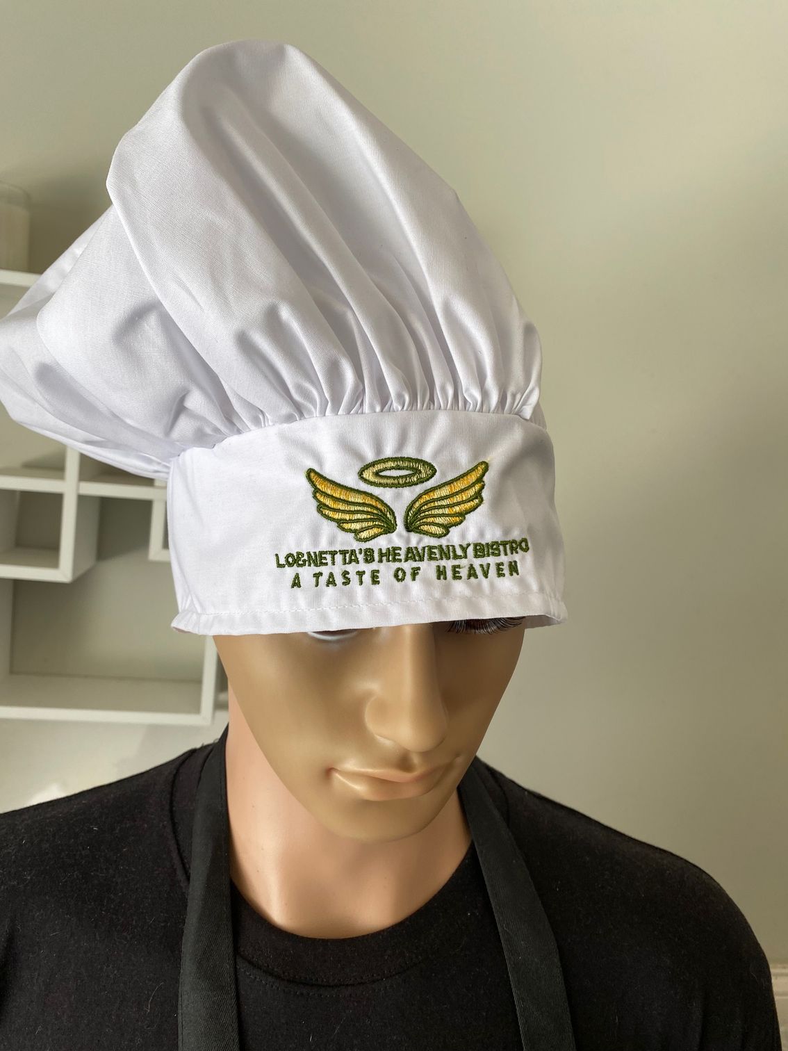 A man wearing a chef 's hat that says a taste of heaven