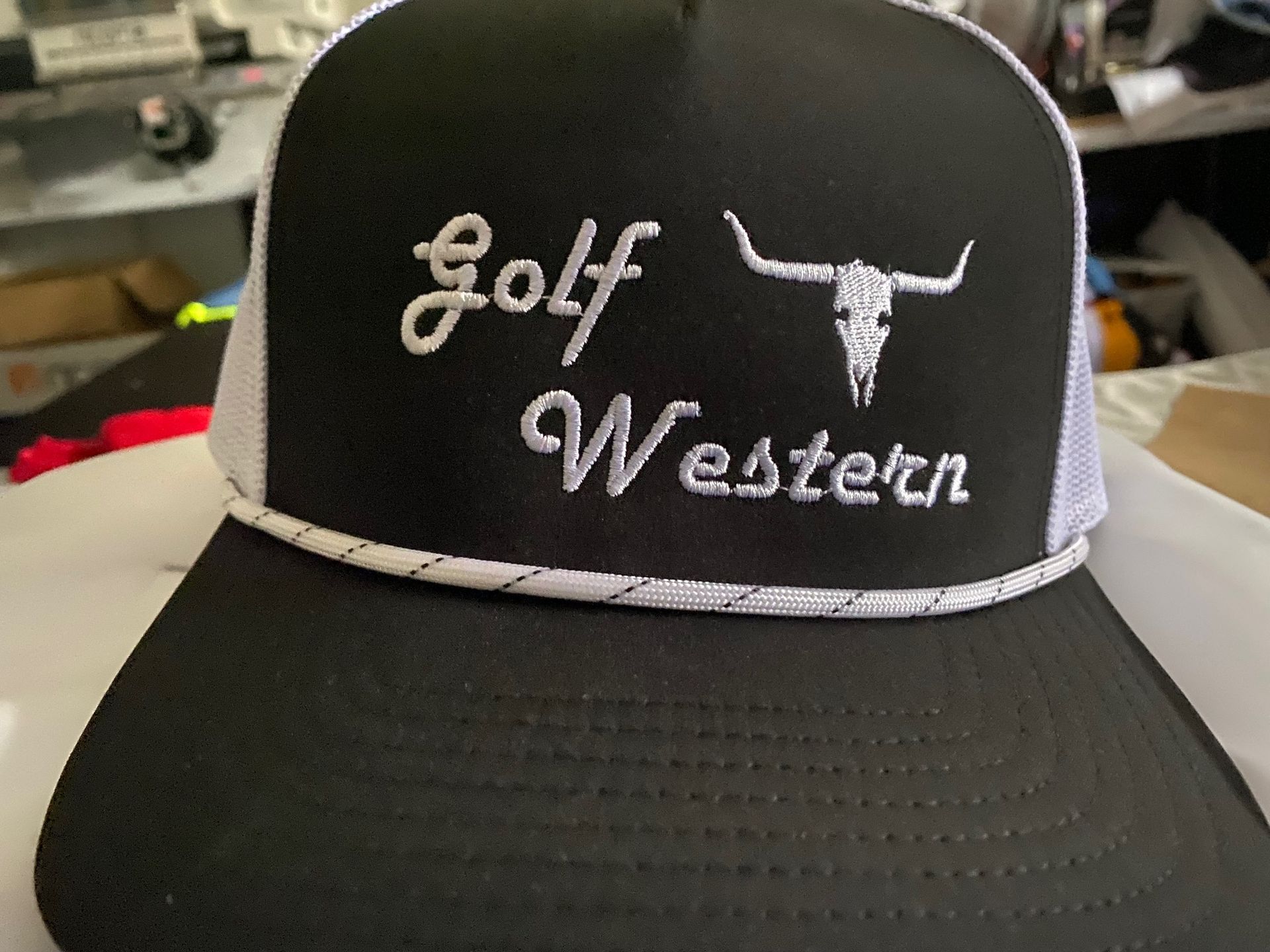 A black hat with the words golf western embroidered on it