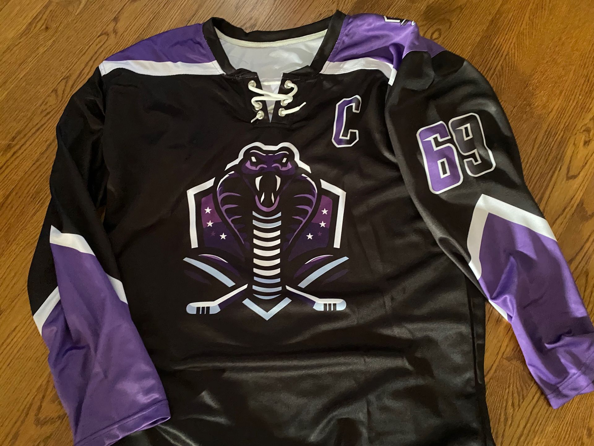 A black and purple hockey jersey with the number 69 on the sleeve