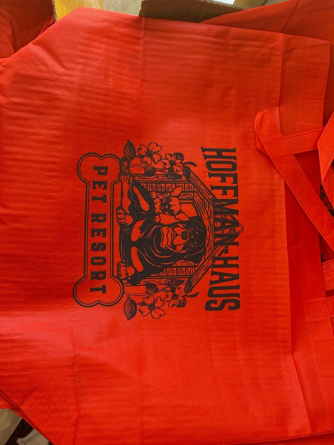 A red bag that says pet resort on it